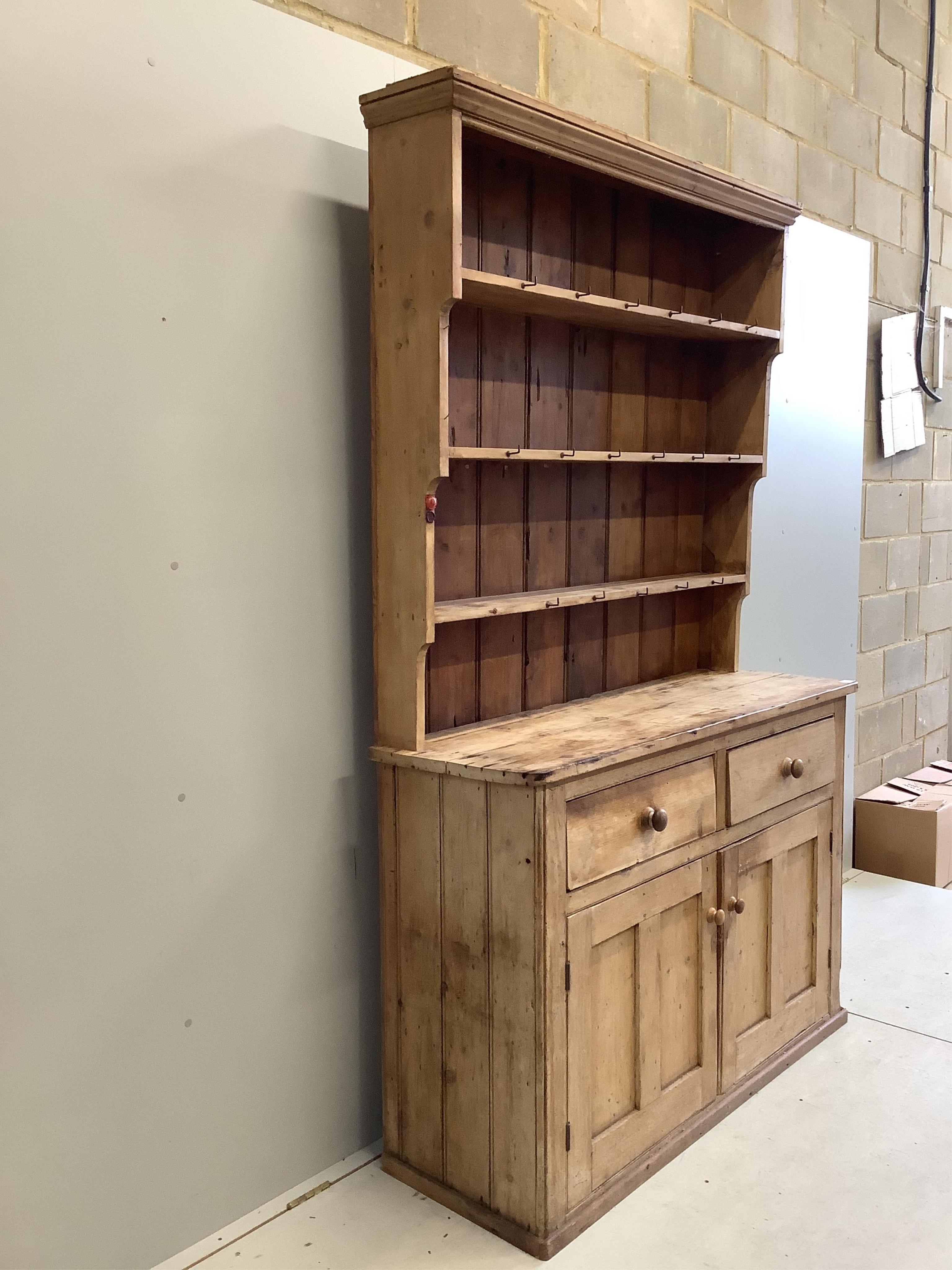 A Victorian pine dresser with boarded rack, width 140cm, depth 46cm, height 223cm. Condition - poor